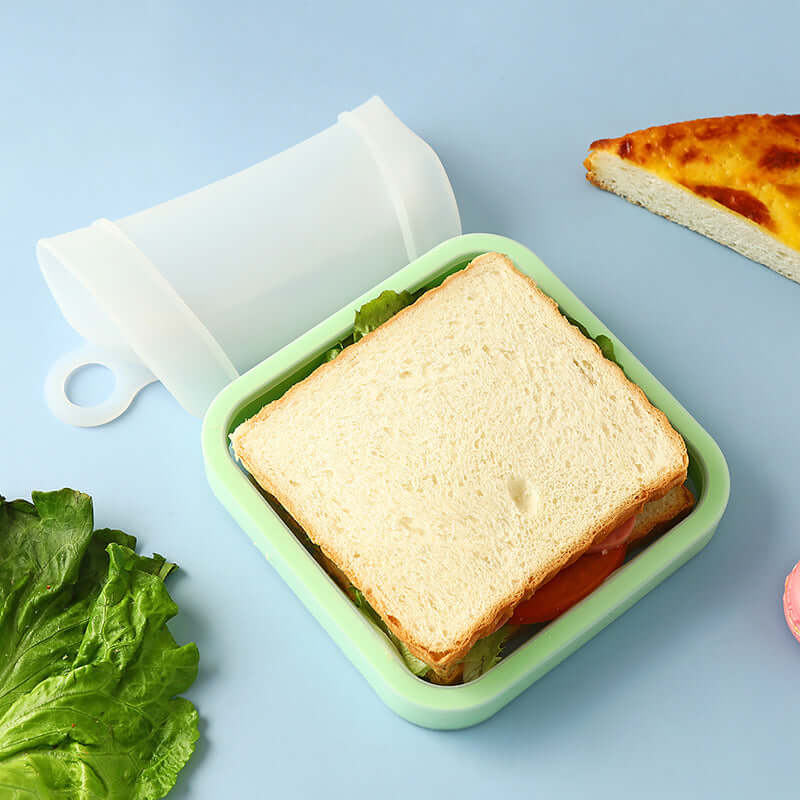 Sandwich in a green container with lettuce and bread on a blue background