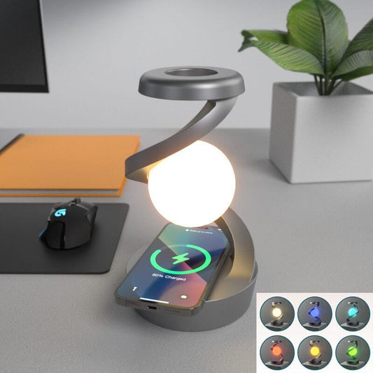 Desk setup with a flexible neck lamp and smartphone on a charging pad, surrounded by office items.