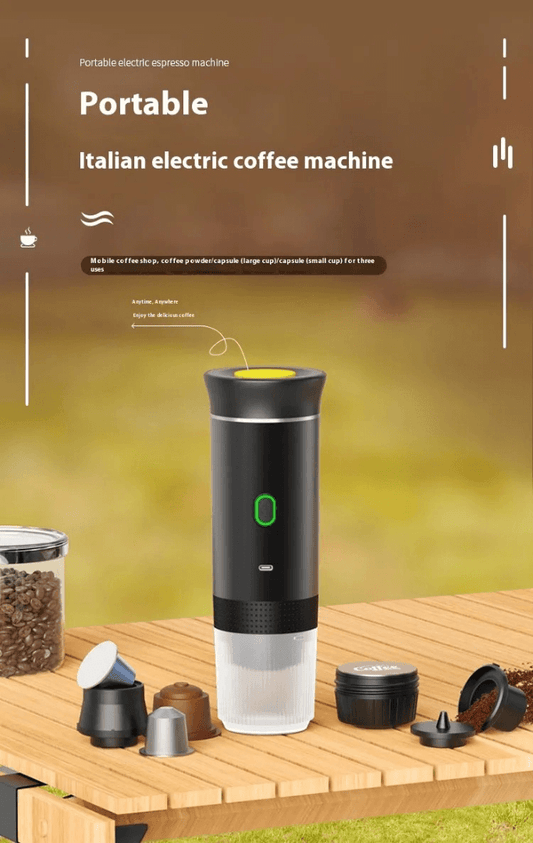 Portable electric espresso machine on a wooden table with coffee capsules and beans.
