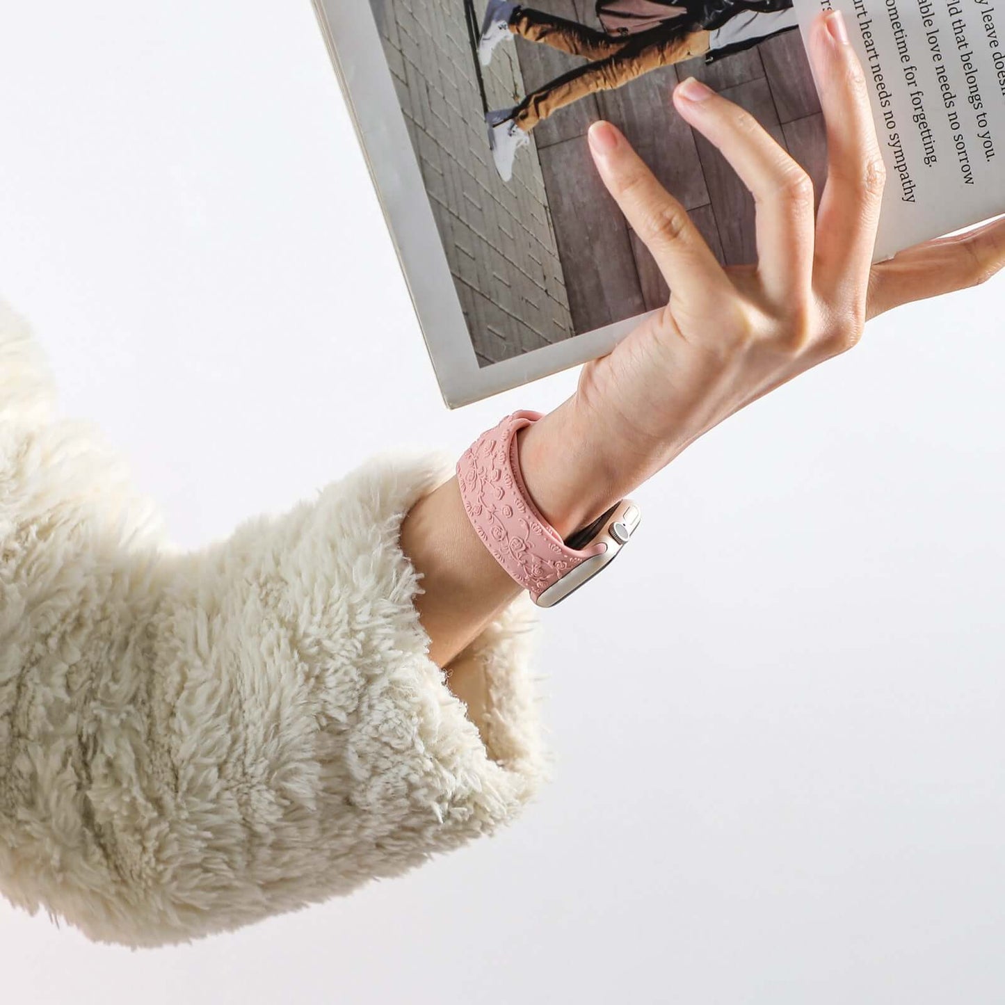 Apple Watch Band in floral silicone strap worn by a woman holding a book, showcasing comfort and style.