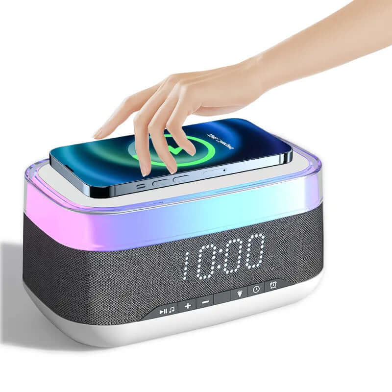 Person placing a smartphone on a 4-in-1 smart alarm clock with wireless charging and LED display.